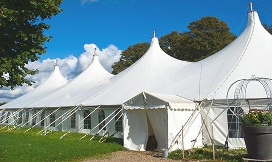 a line of portable restrooms in a shaded area, offering a comfortable experience for users in Mckenna